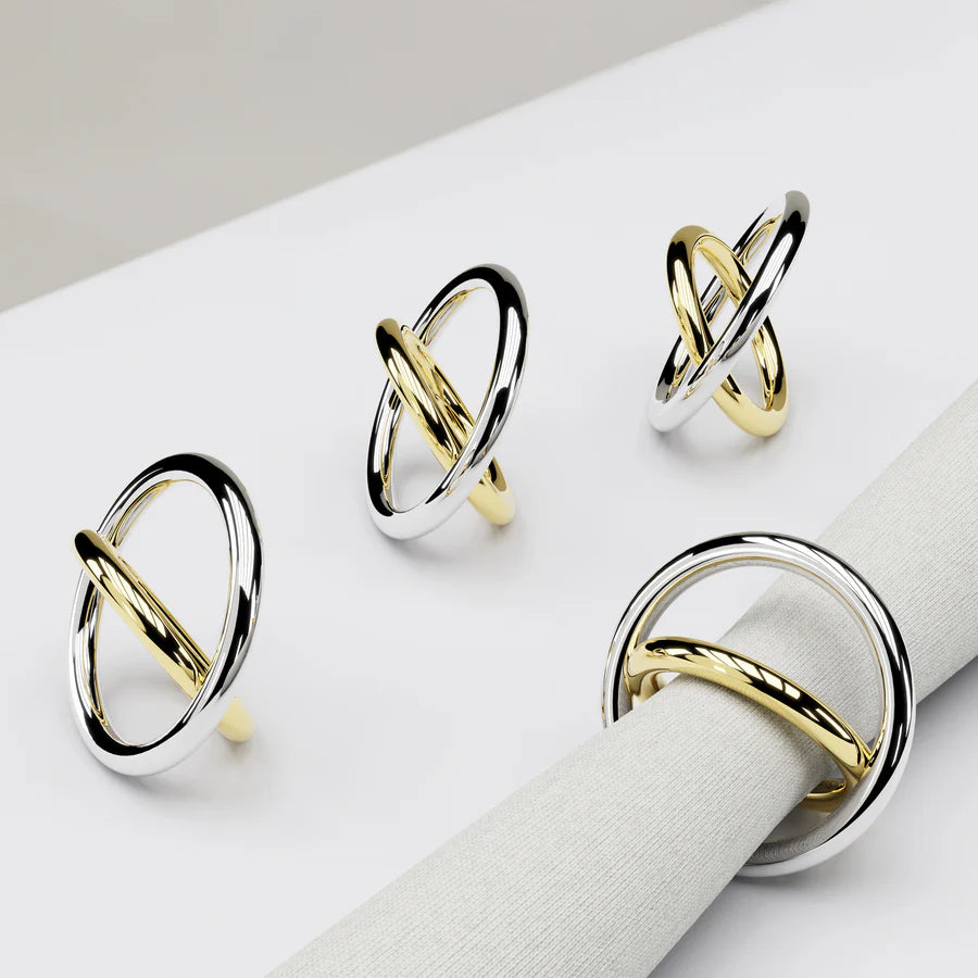 The strength of our Ring Napkin Rings lies in their gold and silver rings leaning against each other—a visual metaphor for the importance of community. Crafted from stainless steel and solid brass, this design is intended as dramatic jewelry for your table, dressing it up or down according to the napkins and tableware you select. Sold as a set of four in a beautifully designed gift box, we hope that its design will encourage people to lean on each other for support.

Stainless Steel and Brass
Imported
Clean
