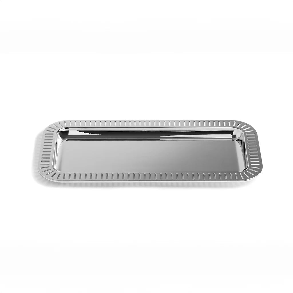 The Striations Rectangular Serving Tray is designed to enhance any entertaining occasion with its classic yet contemporary design. Crafted from premium stainless steel, its sleek design is inspired by the graceful lines of nature, echoing the serene lines of beams of sunlight through trees and glacial landscapes in its intricate patterns. Pair it with the Striations Nut Bowl for a cohesive look, perfect for serving snacks, charcuterie, or even displaying a pair of glasses. Additionally, its versatile design