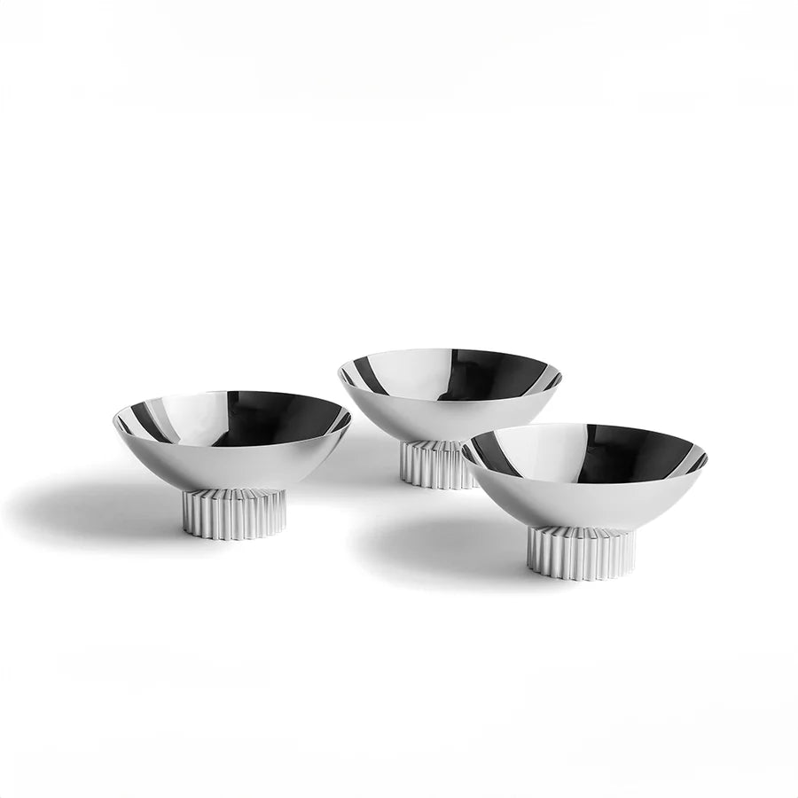Introducing the Striations Trio Bowl Set, a sleek and sophisticated addition to your table. Crafted from durable stainless steel, its modern design draws inspiration from the organic beauty of nature, evoking images of swaying grass blades and mesmerizing glacial grooves in its intricate patterns. Perfect for displaying snacks or even condiments, this timeless design will elevate your entertaining experience.

Plated Stainless Steel
Set of 3
Imported
Clean the pieces right away with mild, soapy water and a 