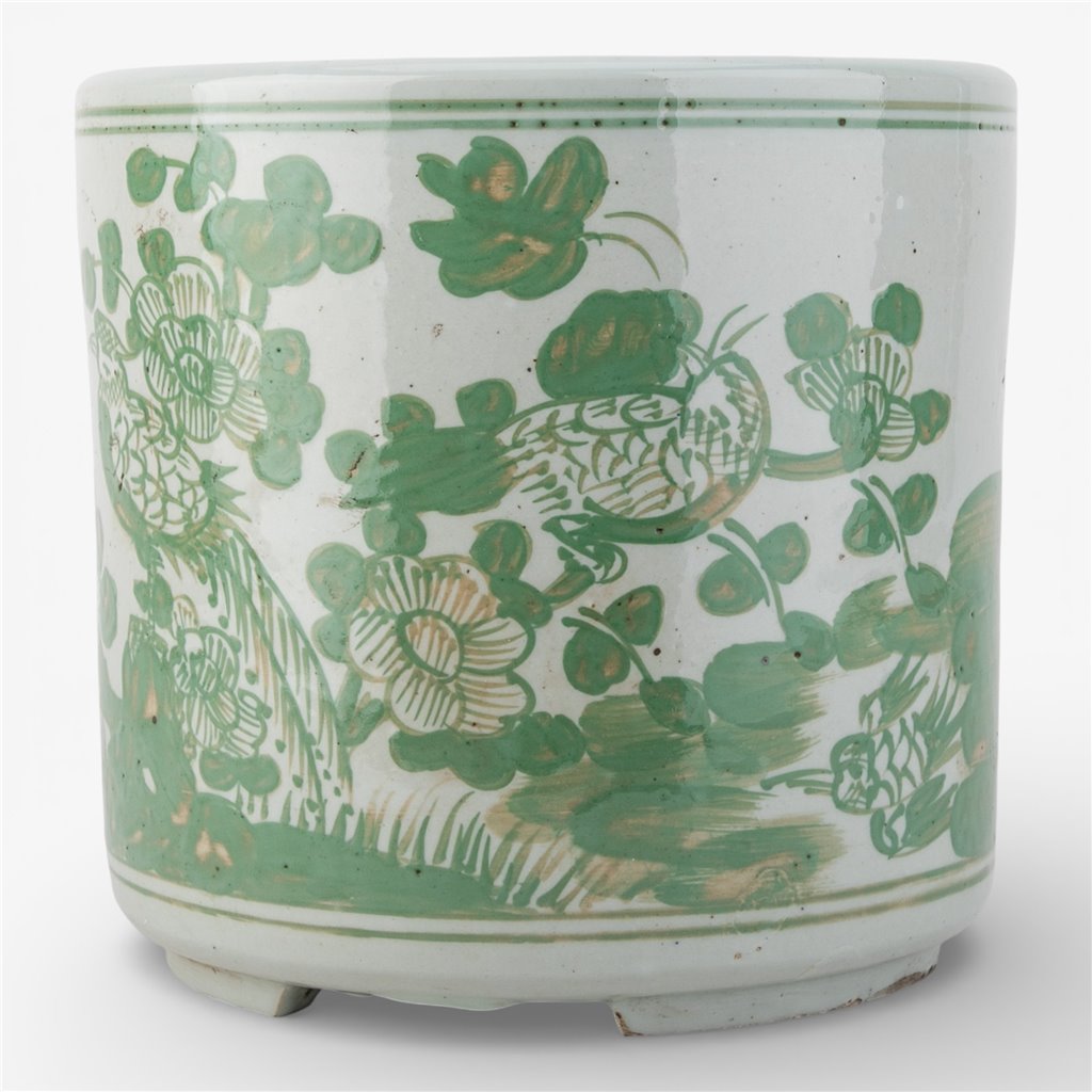 Ceramic pot with green floral and bird patterns.