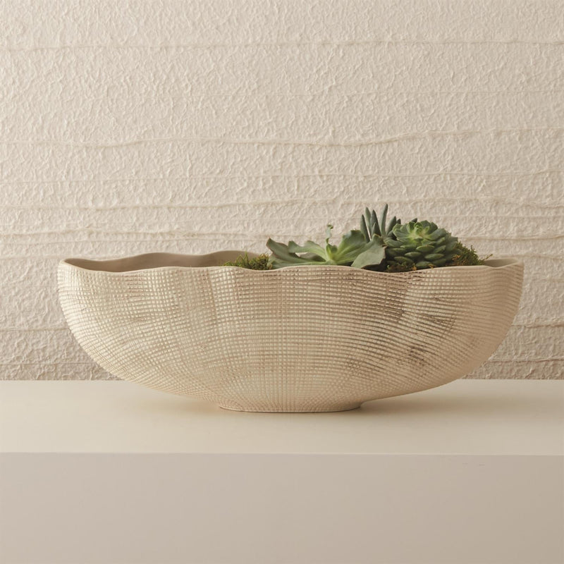 Organic in shape and finish, these stunning pieces feature a grid like texture, adding dimensionality to any space. Handcrafted in Portugal, our Sisal ceramics are the touch of luxury you've been looking for.  Duvall Atelier  Sisal Oval Bowl